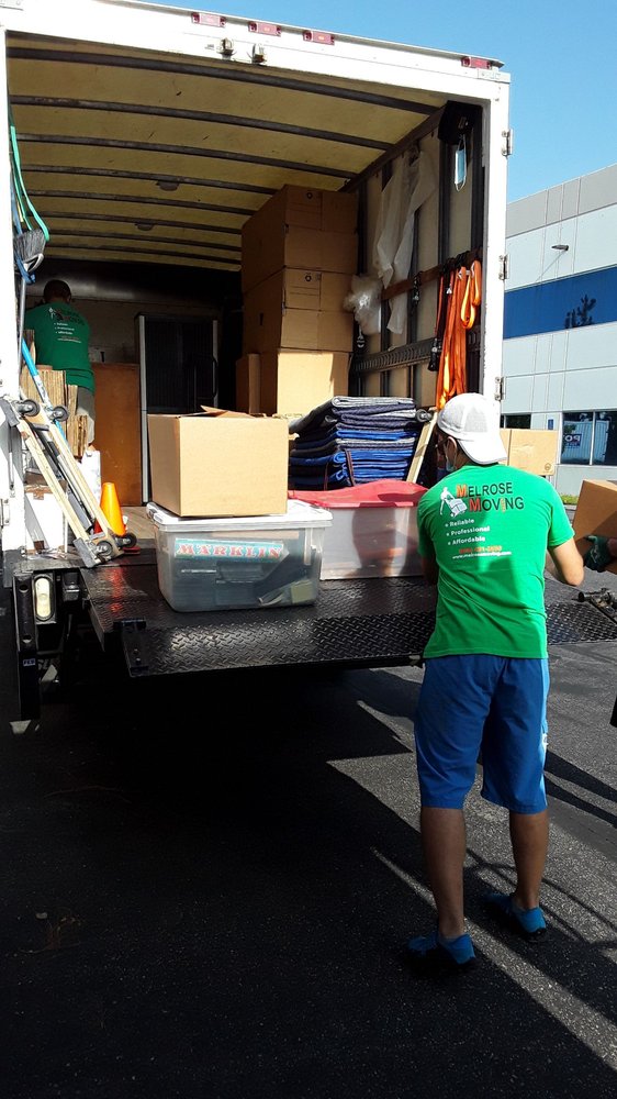 Professional moving service in front of suburban Brentwood home