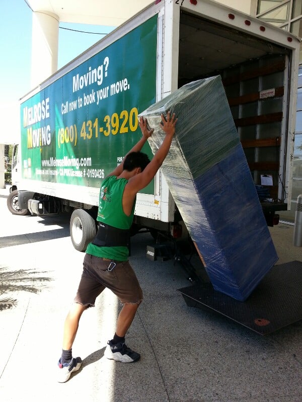 Moving professionals loading boxes into a truck