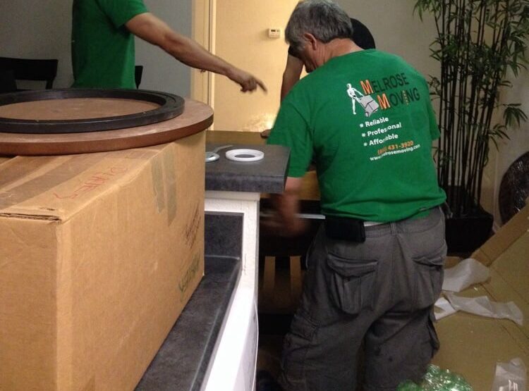 Moving boxes and furniture on sidewalk during Hollywood move