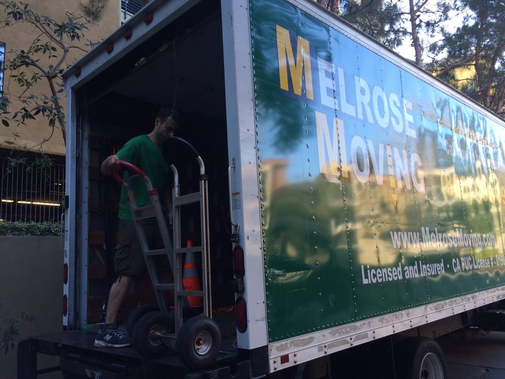 Melrose Moving truck parked near Downey residential area