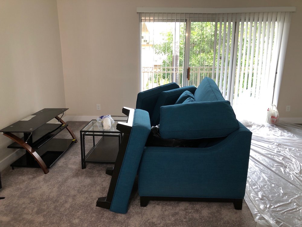 Professional movers loading boxes in East Los Angeles, CA home