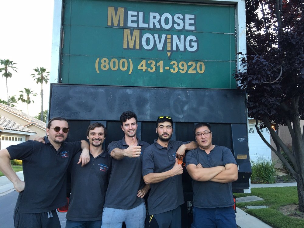 Professional movers loading boxes into moving truck Torrance CA